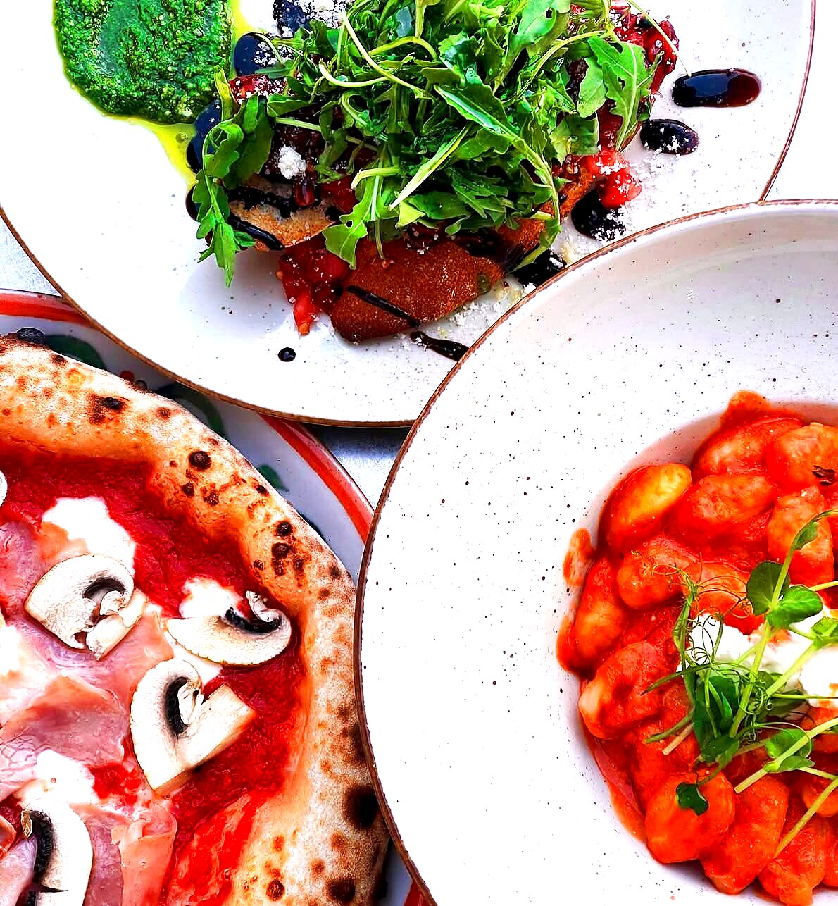 Gnocchi in tomato sauce with burrata — alongside Capriciosa pizza and bruschetta